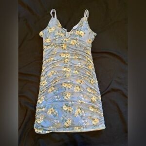 Almost Famous blue body fitting ruched floral strappy dress.​